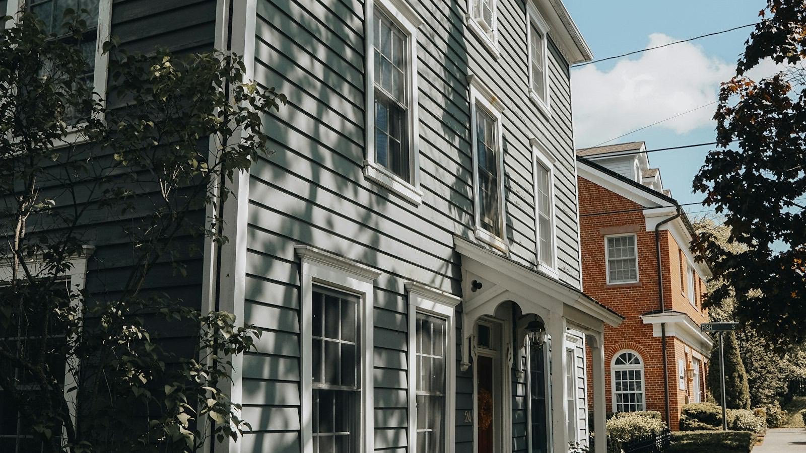 Historic houses line a quaint, sunny small-town street
